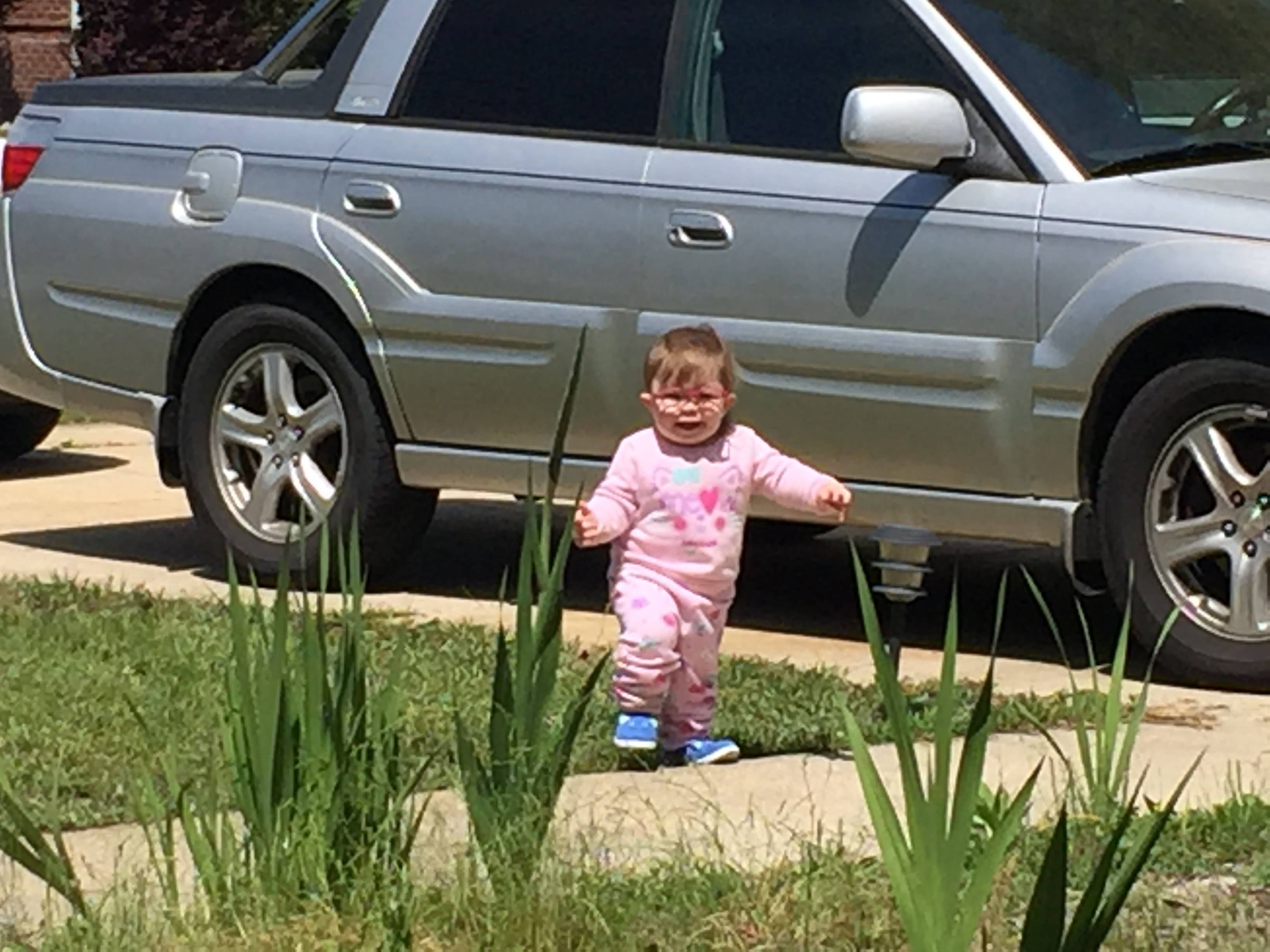 My granddaughter in front of my subaru